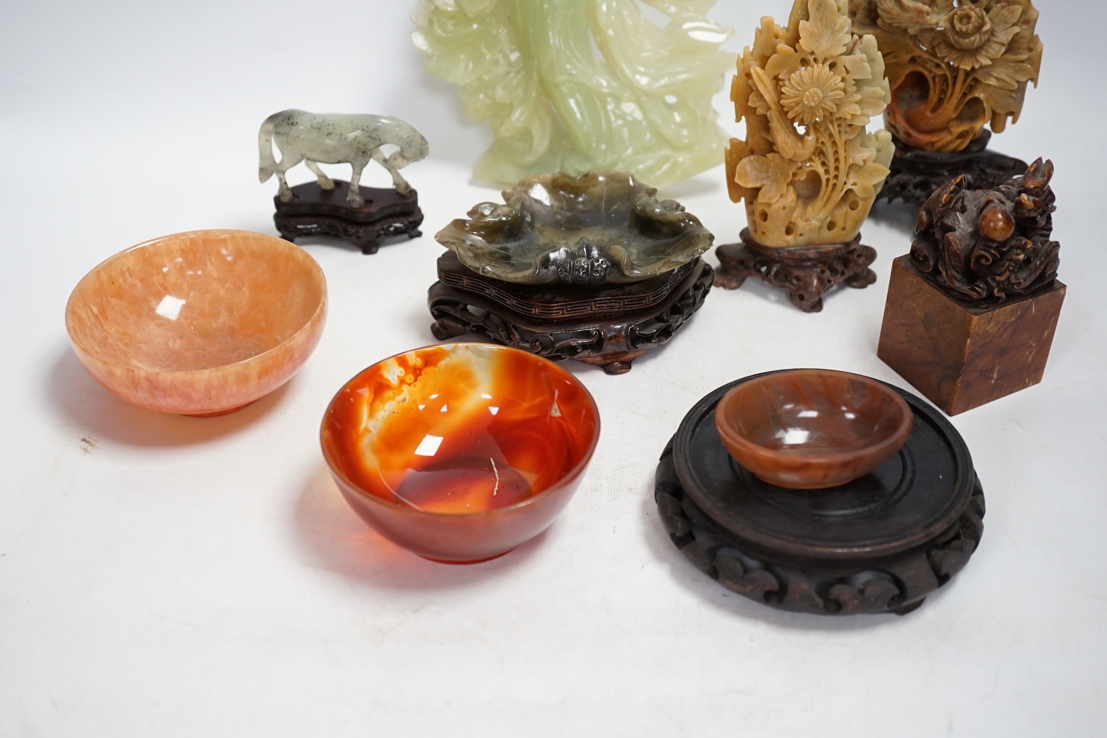 A group of nine Chinese hardstone and soapstone figures, tallest 26cm. Condition - fair